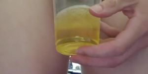 Sissy drinking own piss from cup.