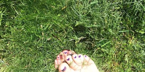 Silky soft young feet playing in freshly cut grass